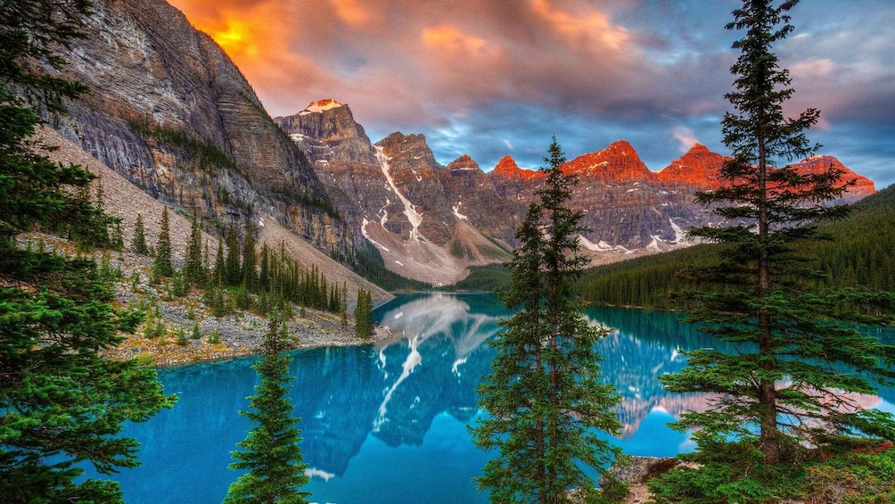 A mountain lake surrounded by forest and rugged peaks. 2