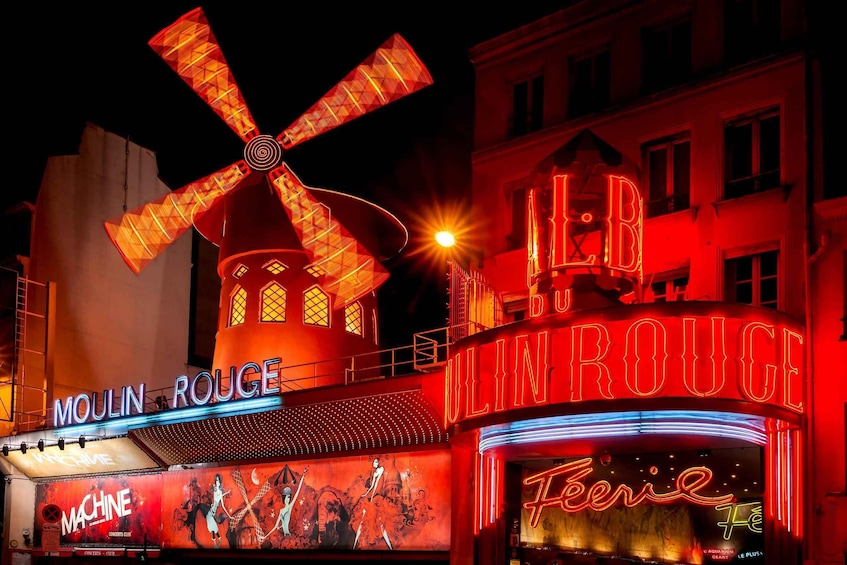 Moulin Rouge with illuminated signs and a windmill. 4