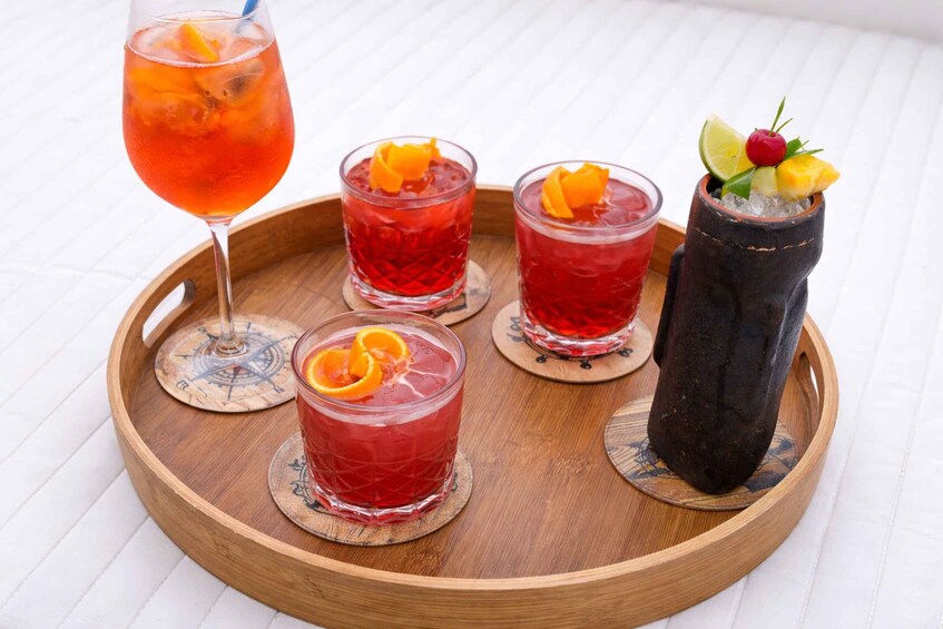 Four drinks on a wooden tray. 3
