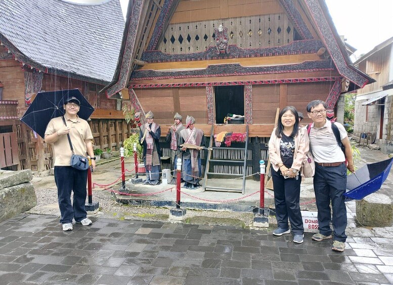 A traditional wooden building with intricate carvings and a tiled roof. 1