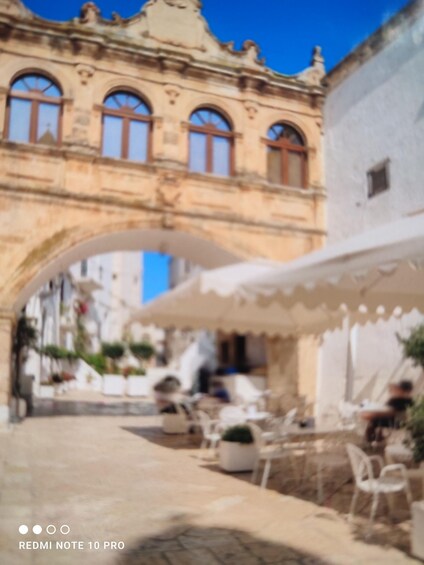 A historic building with arched windows and a white facade. 5