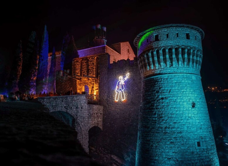 A castle with illuminated structures and a tower. 1