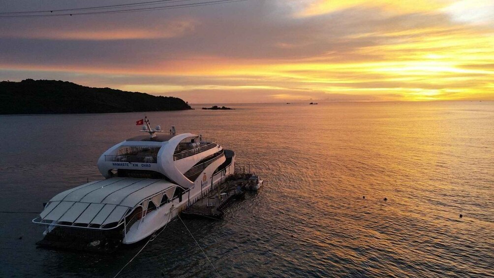 A ferry docked at a pier during sunset. 4