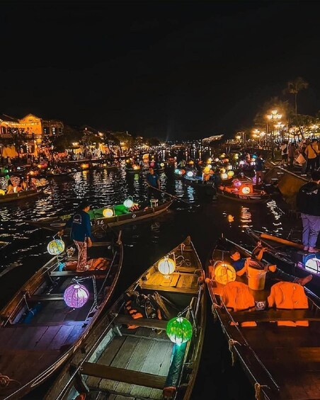 A nighttime river scene with boats and people. 4