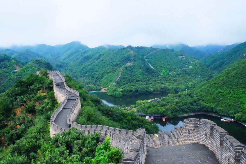 The Great Wall of China winding through lush green hills and valleys. 3