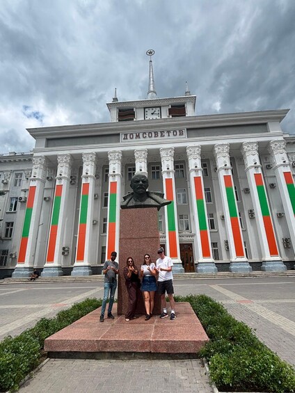 A building with columns and a statue in front. 2