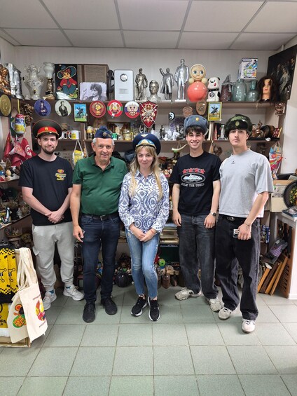A group of people standing in a shop filled with various items like figurines, hats, and memorabilia. 3
