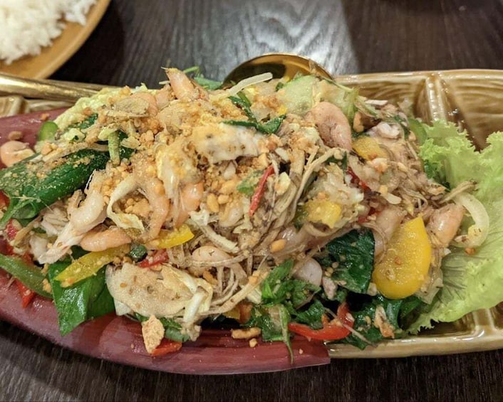 A plate of Thai salad with shrimp, noodles, and vegetables. 5