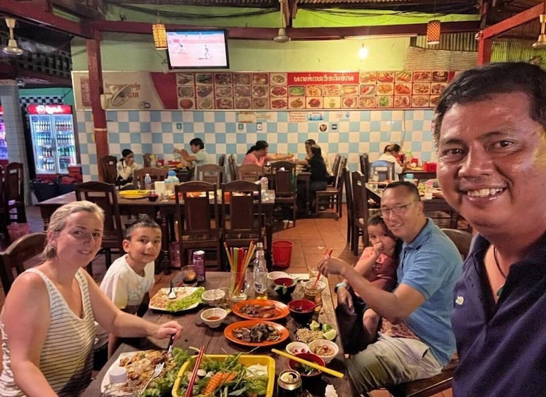 A family dining at a restaurant with a variety of dishes on the table. 2