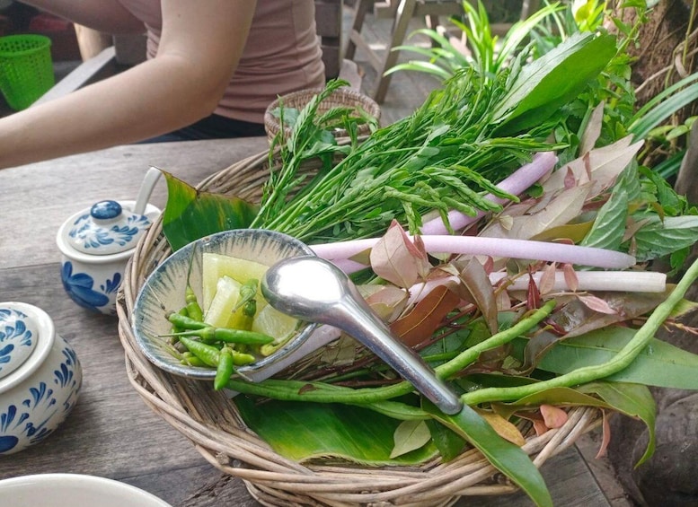 A wicker basket filled with green vegetables and a metal spoon. 4