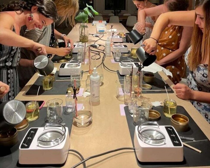 A group of people engaged in a science experiment with various lab equipment and chemicals on a table. 2