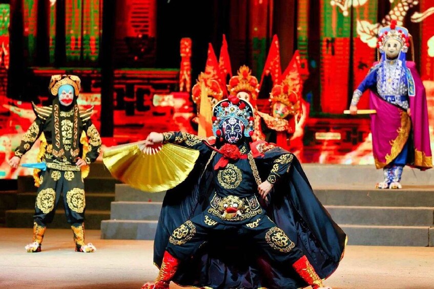 A traditional Chinese opera performance with actors in elaborate costumes and masks. 1