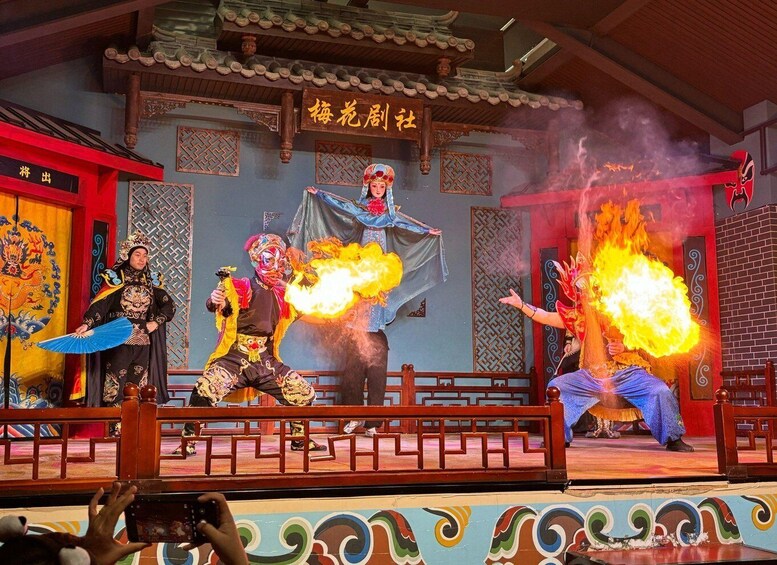 A traditional Chinese performance with actors in elaborate costumes and fire props. 3