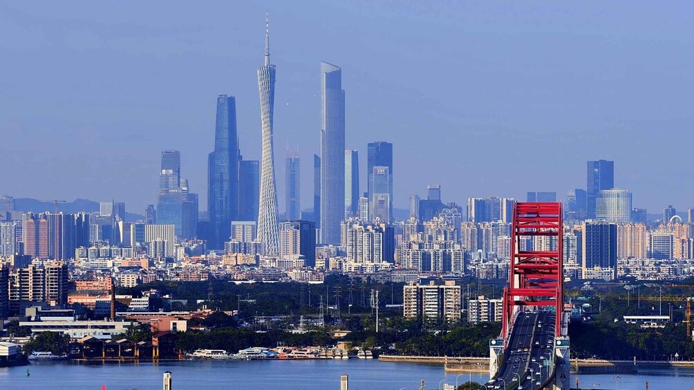 A city skyline with prominent skyscrapers, a bridge, and a body of water. 1