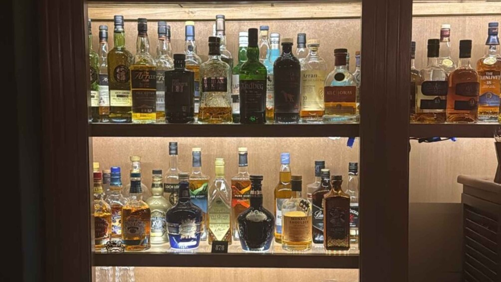 Shelves of various liquor bottles in a store. 3