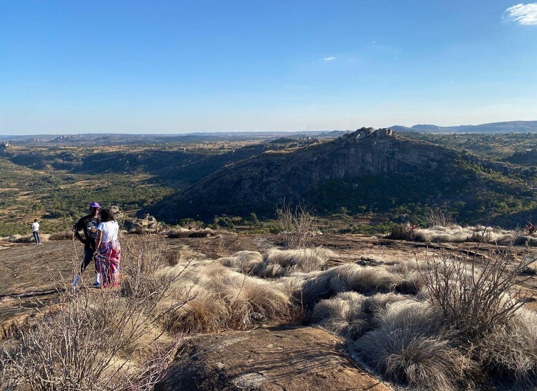 A mountainous landscape with dry grass and a clear sky. 2