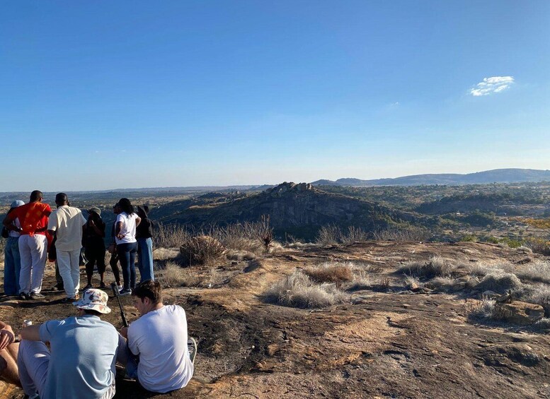 A group of people on a hillside overlooking a valley. 1