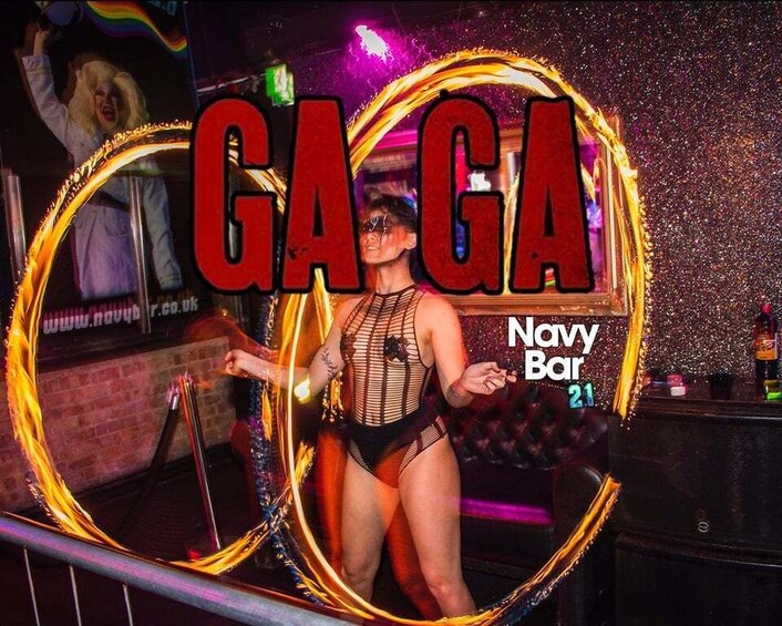 A person performing with a hula hoop in a club setting. 4
