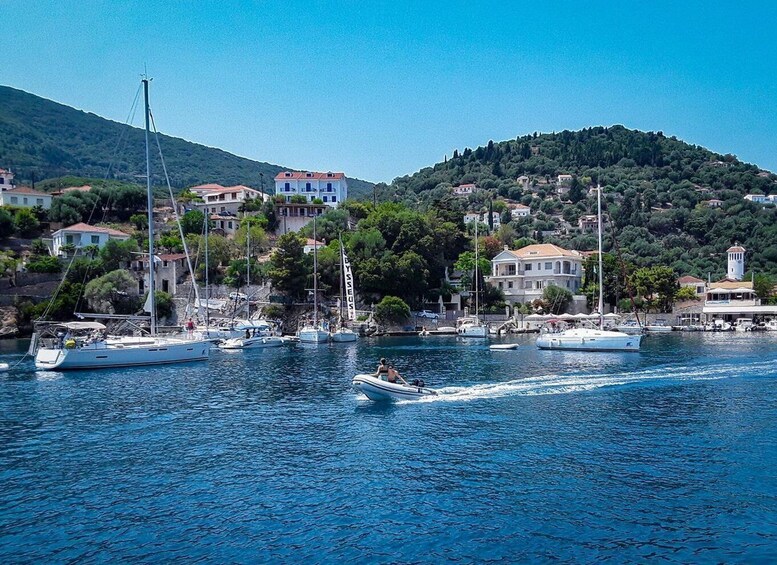 A coastal town with boats docked, a lighthouse, and buildings on a hillside. 4