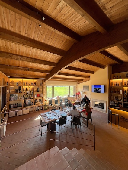 A restaurant with wooden ceilings, a bar area, and a dining space with tables and chairs. 2