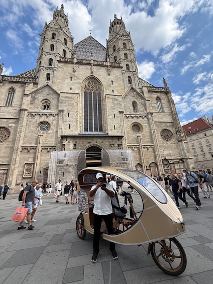 A historic cathedral with two towers, a large central window, and a crowd of people in front. 2