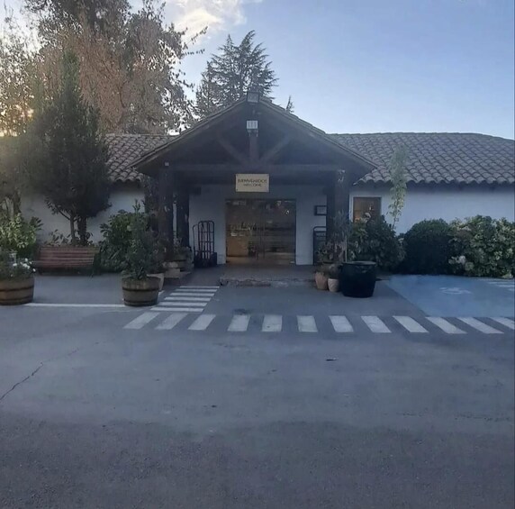 A building with a sign that reads 'WELCOME' and a covered entrance. 4