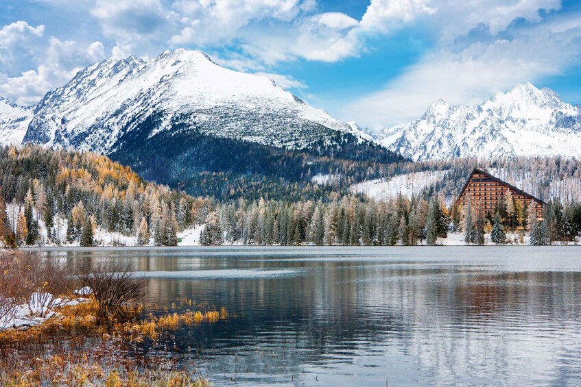 A mountain range with a lodge by a lake. 5