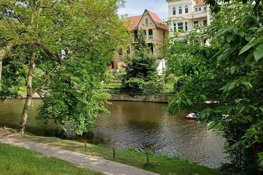 A river, a pathway, and buildings in the background. 5