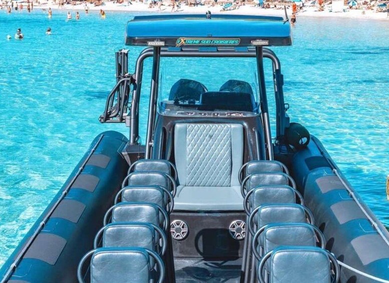 A blue inflatable boat with seating and a canopy, floating on clear blue water. 3