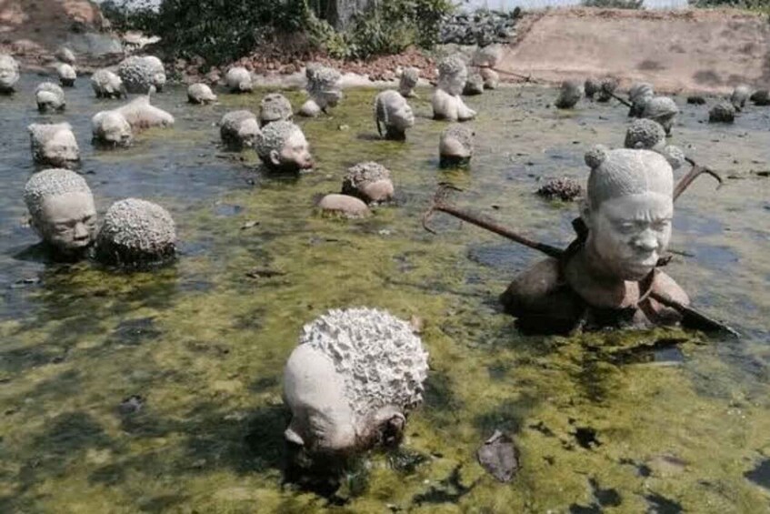 Numerous stone sculptures in a shallow water body. 2