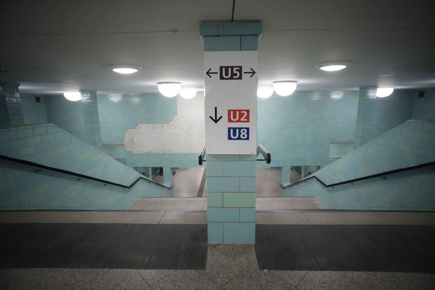 A subway station with directional signs for U5, U2, and U8. 3