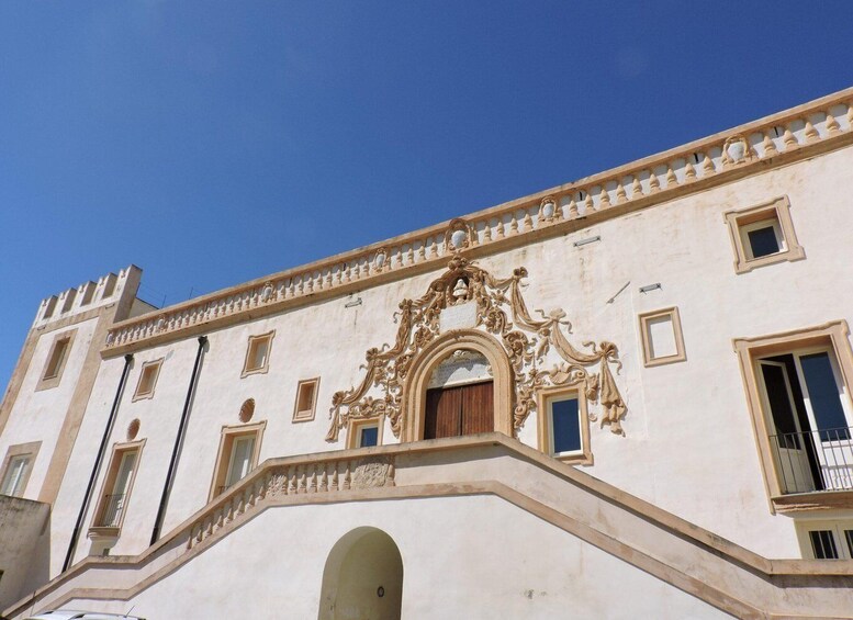 A historic building with ornate architectural details, including a grand staircase and a large arched doorway. 4