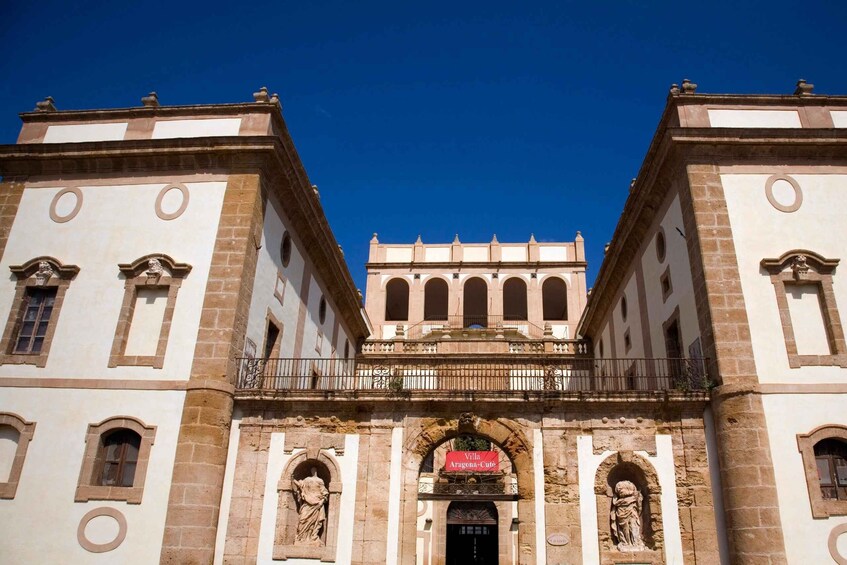 A historic building with arched windows and a balcony. 3