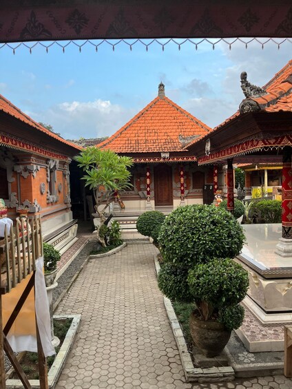 A courtyard with traditional architecture, including tiled roofs and ornate decorations. 5
