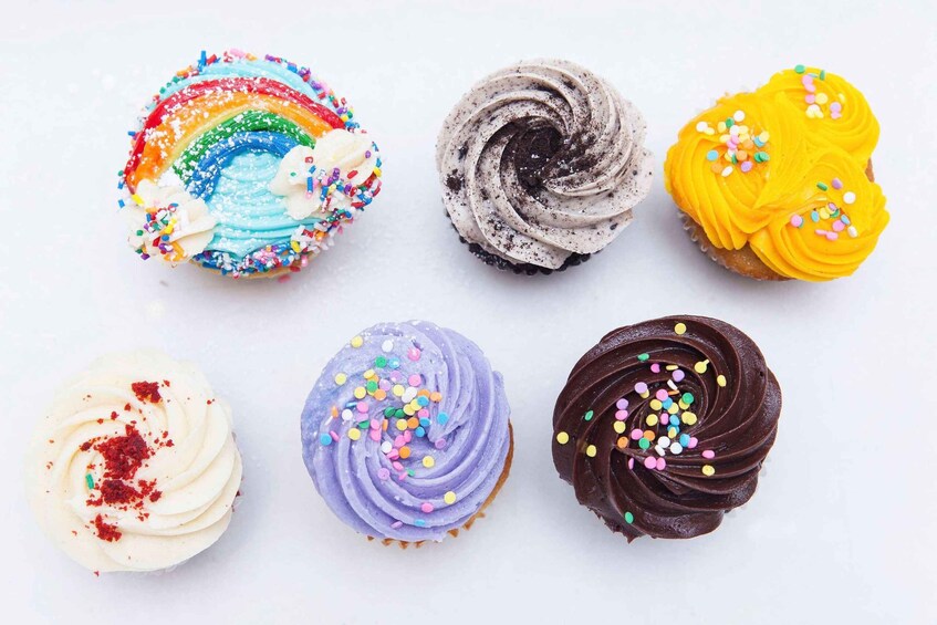 Six cupcakes with various frosting colors and sprinkles. 3