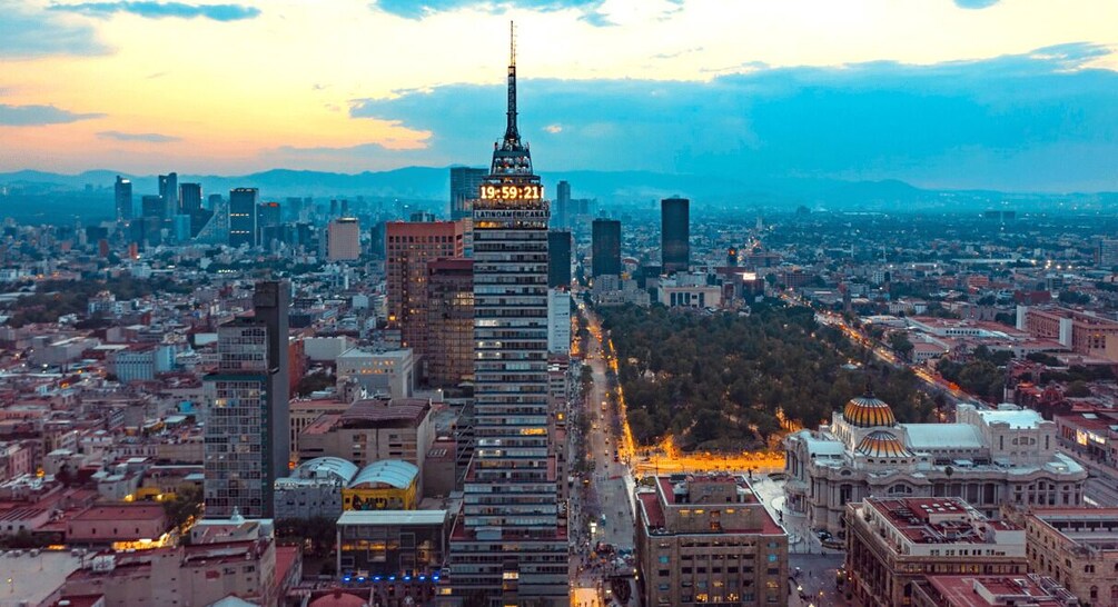 A cityscape with a prominent skyscraper, a domed building, and a dense urban environment. 1