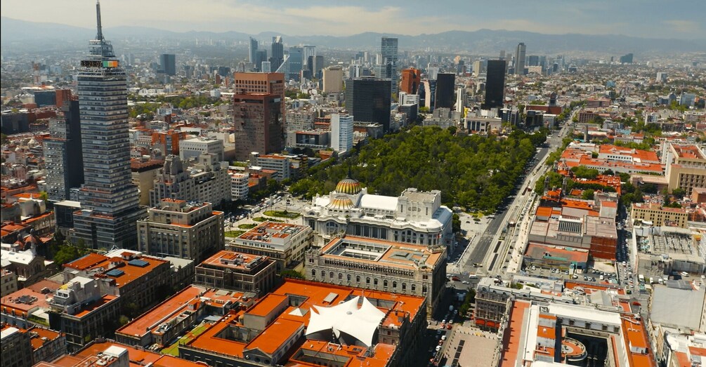 A cityscape with prominent skyscrapers, a central plaza with a dome, and surrounding urban buildings. 4