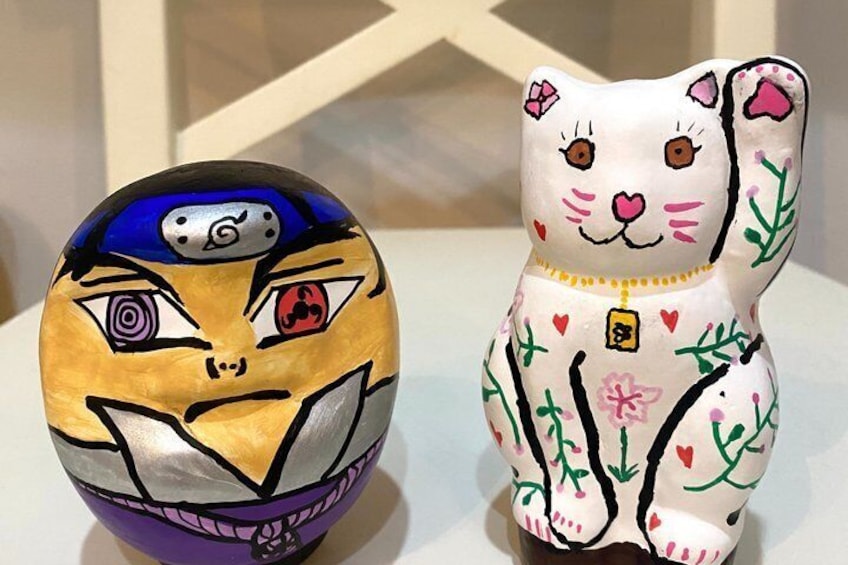 Two painted objects, one resembling a cat and the other a bear, with intricate designs and patterns. 3