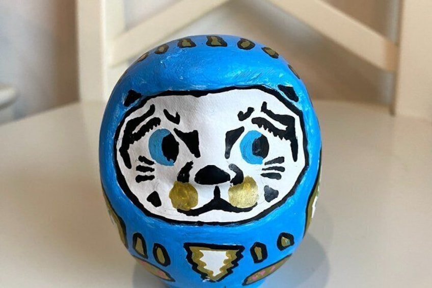 A painted egg with a blue and white design. 5