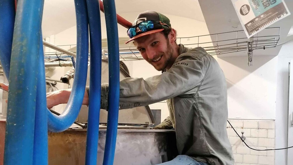 A person working with blue hoses in an industrial setting. 4