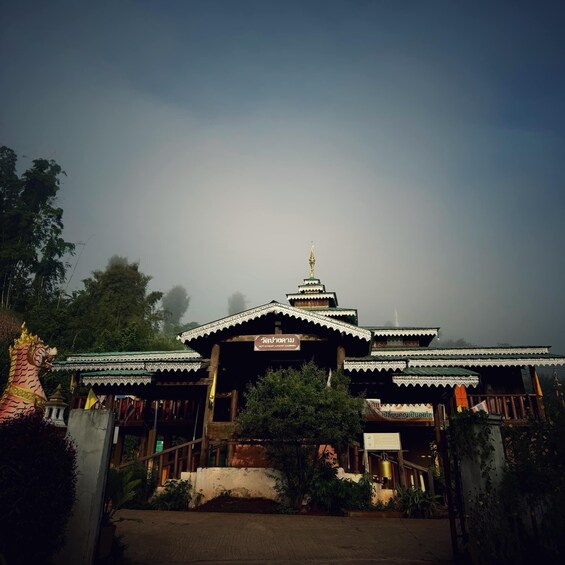 A traditional temple with a golden spire, surrounded by lush greenery. 3