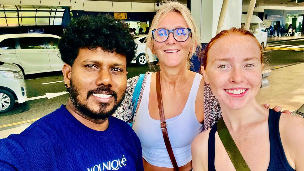 Three people taking a selfie at an airport terminal. 3