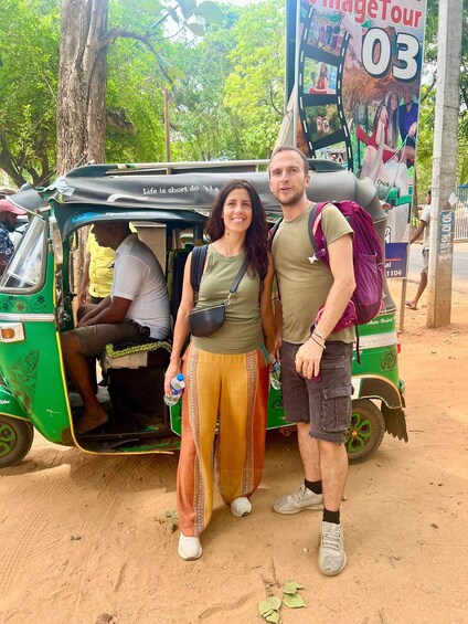 Two people standing in front of a green auto-rickshaw with a sign that reads 'Image Tour 03'. 4