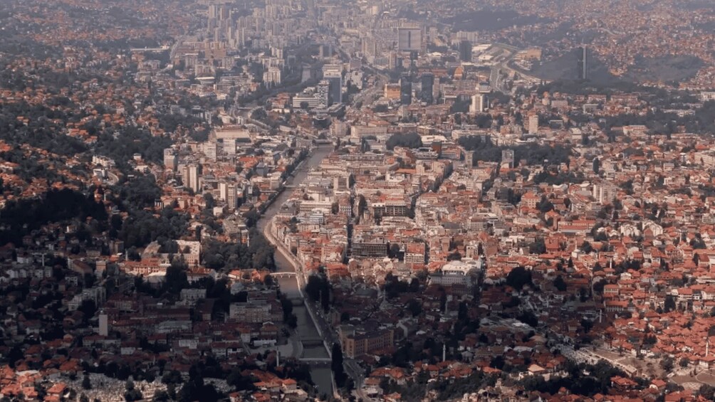 An aerial view of a densely populated city with a prominent river running through it. 3