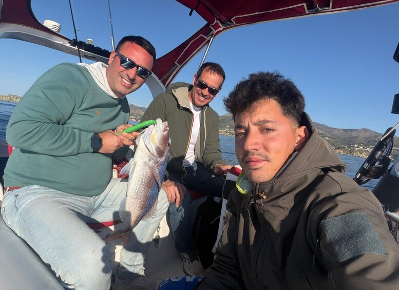 Three people on a boat with a fish. 5