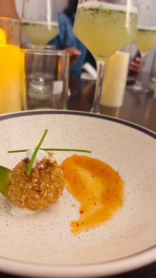 A plate with a food item, a sauce, and a garnish. 2