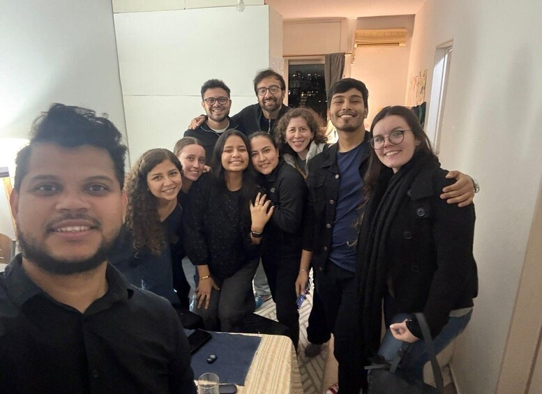 A group of people in an indoor setting with a table and chairs. 4