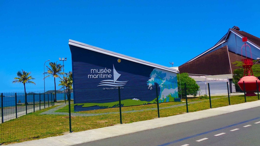 A large mural advertising the Musée Maritime with a coastal scene. 2