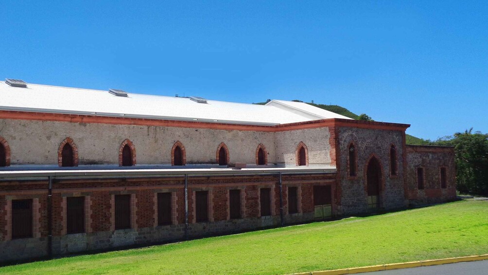 A large, historic building with a white roof and red brick arches. 3