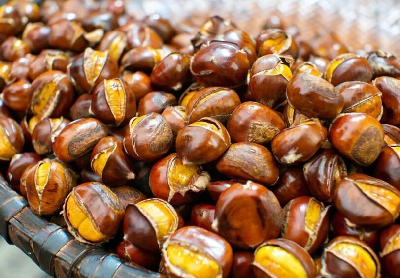 A close-up of chestnuts with their shells partially peeled. 4
